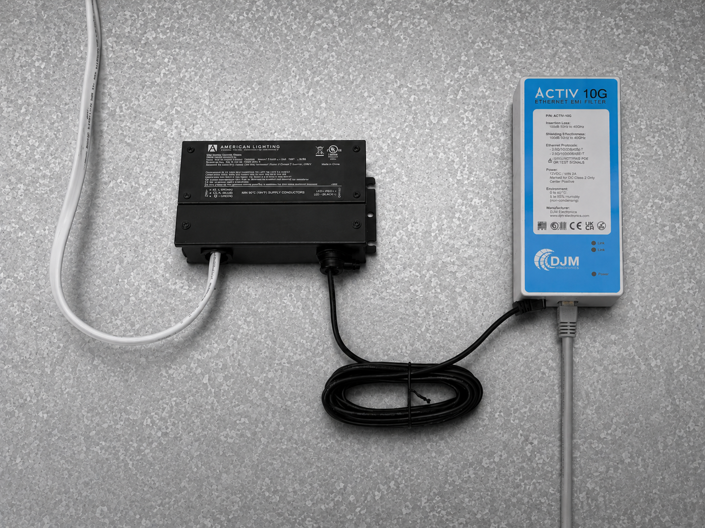 ACTIV 10G HW Kit installed above a drop ceiling, showing the junction box, cordset, and ACTIV 10G filter mounted through the shield wall